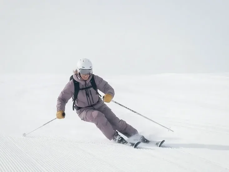 A skier carving a freshly groomed piste
